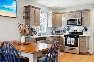6-person dining table and kitchen area located on the second level.