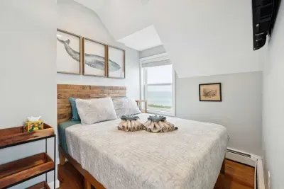 Bedroom #2 with a queen sized bed and an ocean view! Clean linens are provided.