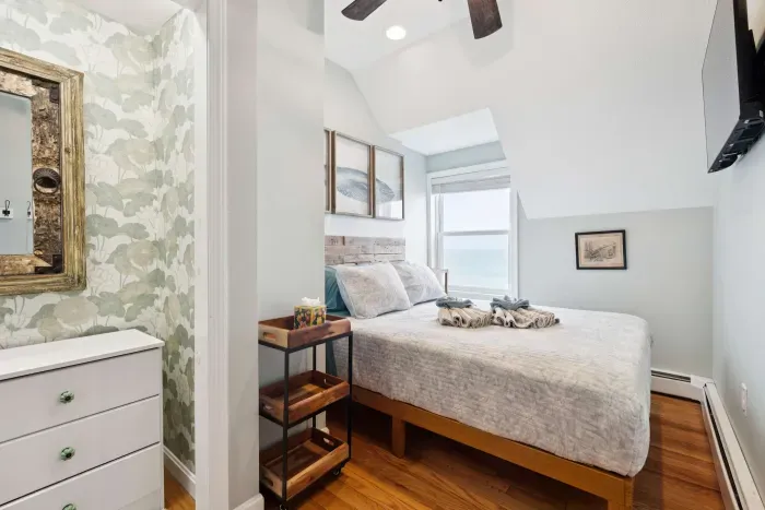 Bedroom #2 with a full sized bed and ocean view. Clean linens are provided.