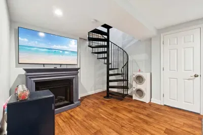 Ground floor living area with electric fireplace and smart TV