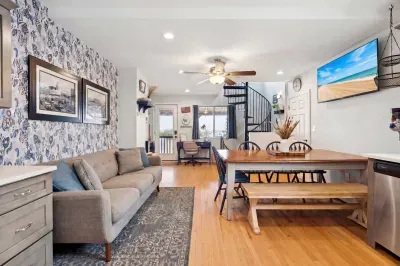 Living room with smart TV, couch and dining area