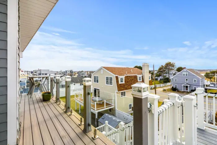 The back deck of the penthouse with Salisbury marsh views, and access via the back staircase to the backyard and parking area