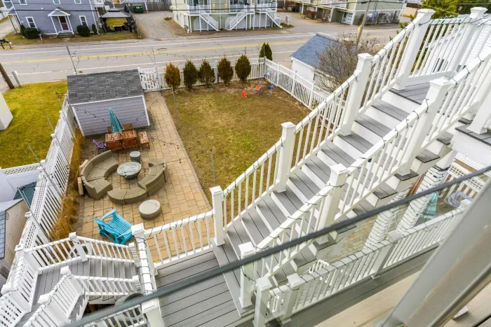 The back deck of the penthouse with Salisbury marsh views, and access via the back staircase to the backyard and parking area
