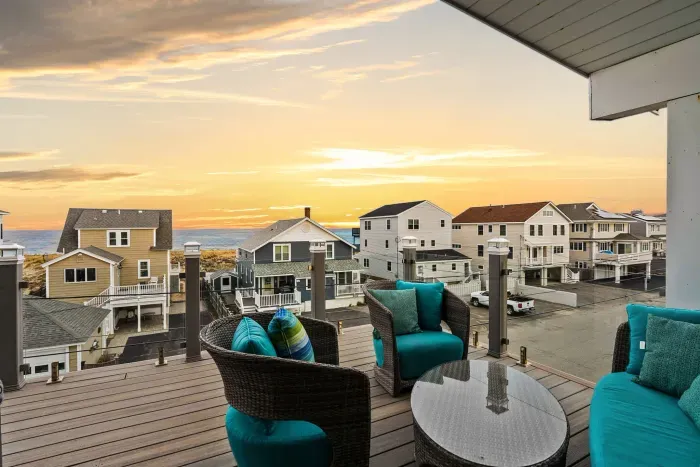 Water views from the rooftop deck! Outdoor furniture including a swing chair. Access to the living area and primary bedroom. 