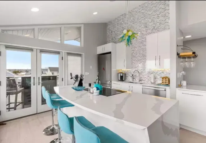 Completely renovated and fully equipped kitchen with high end Miele appliances, including an induction stove top and dishwasher. Seating for 4 at the island + 2 at the peninsula