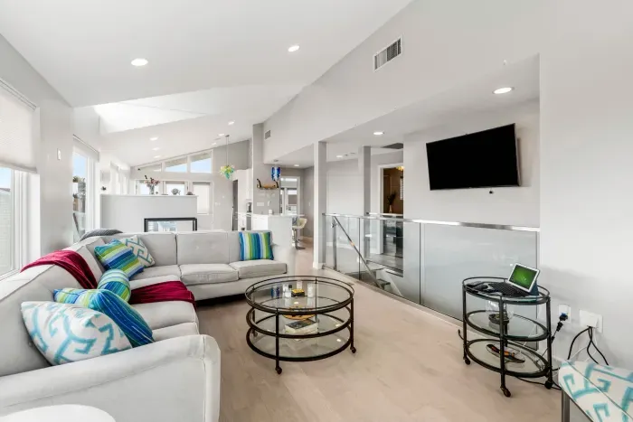 Living area with large sectional couch, smart TV, ocean views, and a gas fireplace!