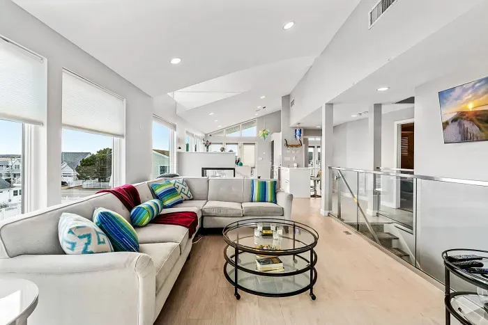 Living area with large sectional couch, smart TV, ocean views, and a gas fireplace!