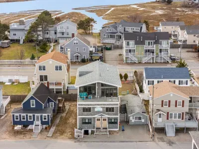 An aerial view of the home and Salisbury Beach! This property is literally across the street from the sand!