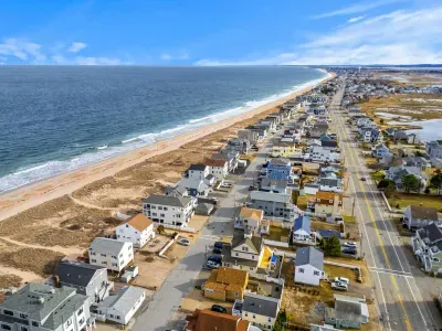 An aerial view of the home and Salisbury Beach! This property is literally across the street from the sand!