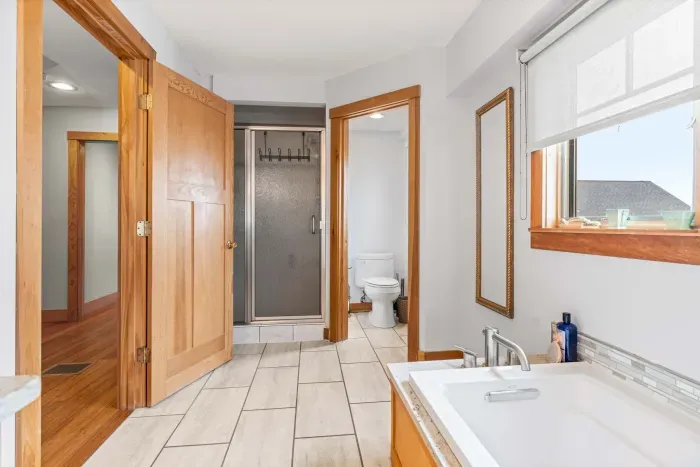 The second bathroom in the Yoga unit with a stacked washer and dryer, soaking tub and tiled shower! Clean towels provided for all guests. 