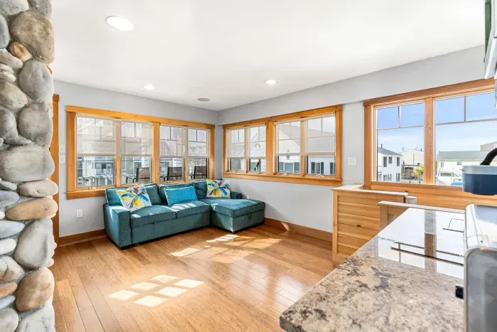 Yoga unit living area with additional exit, gas fireplace, and small kitchenette with a sink, coffee maker and mini fridge. This pullout couch will fit 2 younger kids or 1 adult