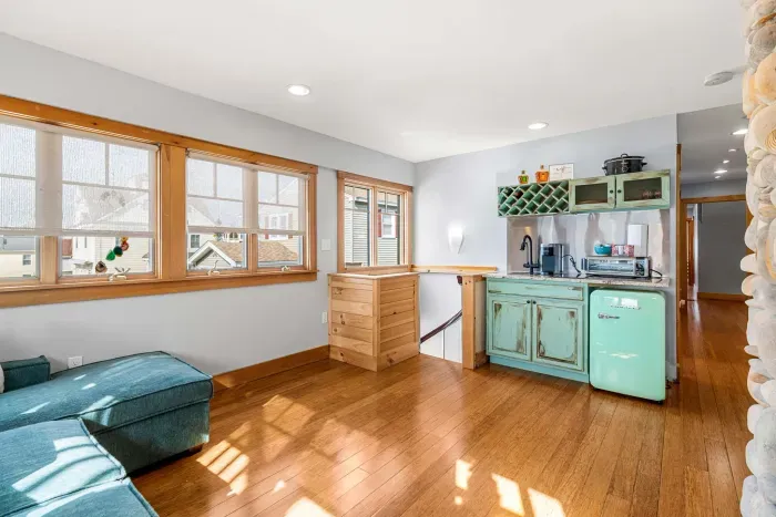 Yoga unit living area with additional exit, gas fireplace, and small kitchenette with a sink, coffee maker and mini fridge. This pullout couch will fit 2 younger kids or 1 adult