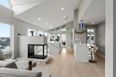 Living area with large sectional couch, smart TV, ocean views, and a gas fireplace!