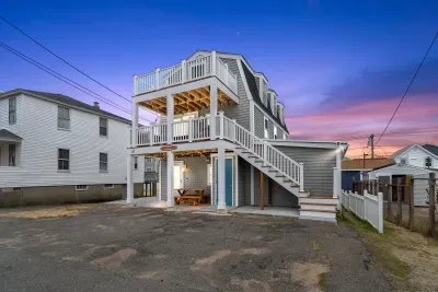 Exterior of property. This unit is located on the 2nd and 3rd floors, and comes with 2 off-street parking spots (parked side-by-side on the ride-hand side of the driveway)