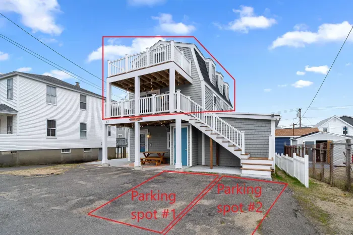 Exterior of property. This unit is located on the 2nd and 3rd floors, and comes with 2 off-street parking spots (parked side-by-side on the ride-hand side of the driveway)