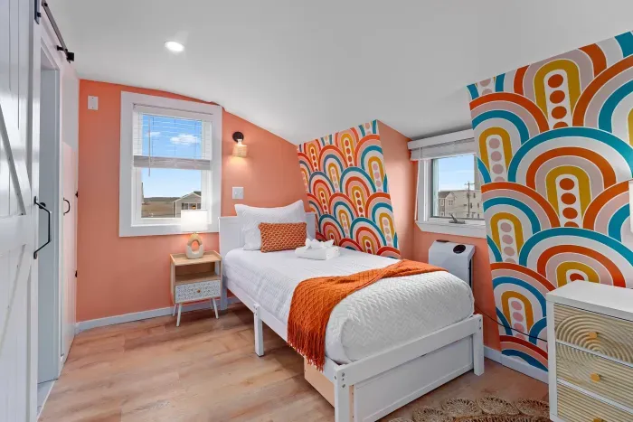 Bedroom #2 with two twin beds, mounted smart TV and ensuite bathroom with walk-in tiled shower.