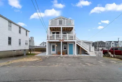 Exterior of property. This unit is located on the 2nd and 3rd floors, and comes with 2 off-street parking spots (parked side-by-side on the ride-hand side of the driveway)