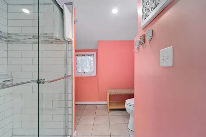 Bedroom #2 with two twin beds, mounted smart TV and ensuite bathroom with walk-in tiled shower.