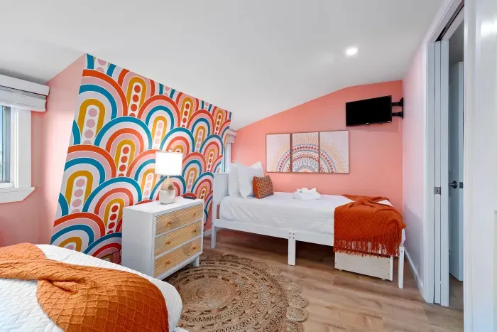 Bedroom #2 with two twin beds, mounted smart TV and ensuite bathroom with walk-in tiled shower.