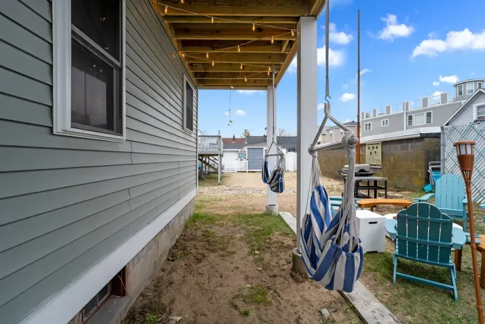 Common back yard area, with common amenities shared with the unit upstairs -- string lights, gas firepit, sitting area, hammock, swinging chairs - WE NO LONGER HAVE A GRILL