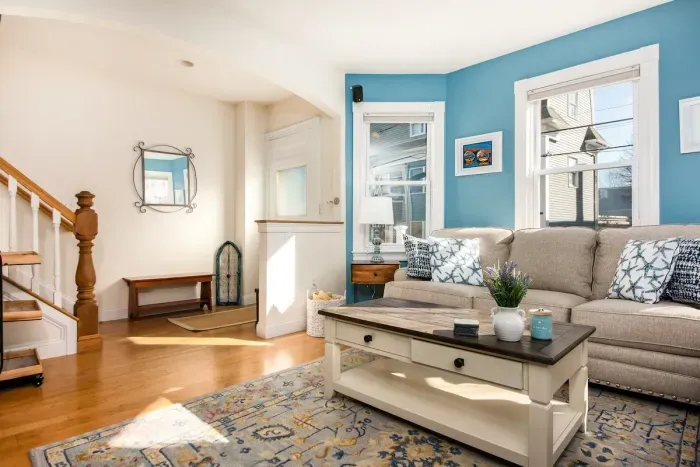 Large, sunny and comfortable living room with mounted TV and electric fireplace for all guests to enjoy.