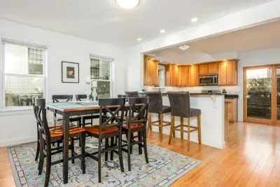 The open concept dining room and kitchen offers an abundance of space for several cooks in the kitchen and friends and family to dine.