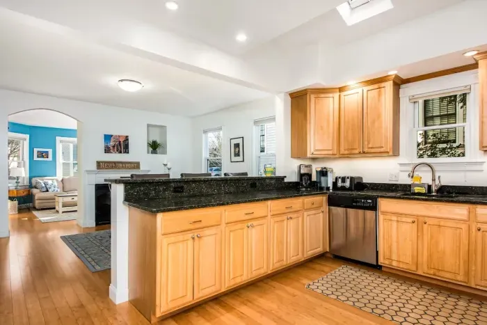 The open concept dining room and kitchen offers an abundance of space for several cooks in the kitchen and friends and family to dine. (Keurig coffee maker not available)