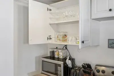 Fully equipped kitchen with all the essentials including glassware, plates, and utensils
