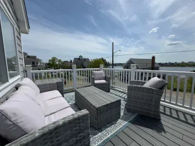 The balcony with outdoor seating, dining, and views of the Plum Island Basin!