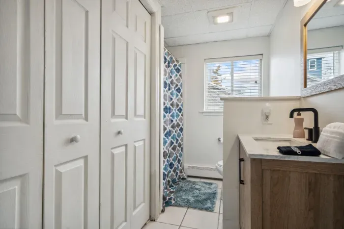 The downstairs bathroom! The washer and dryer are located in this closet. There is a standing shower in this bathroom. Clean towels provided for all guests