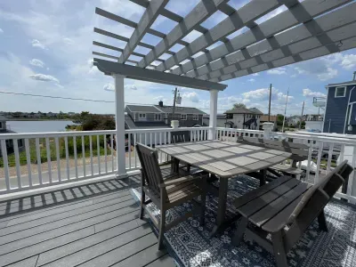 The balcony with outdoor seating, dining, and views of the Plum Island Basin!