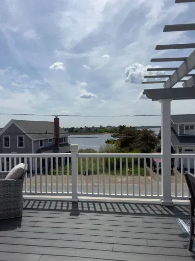 The balcony with outdoor seating, dining, and views of the Plum Island Basin!