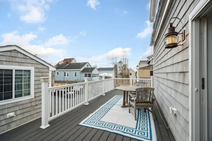 The back deck! There is access to the back deck from the primary bedroom and the side entrance