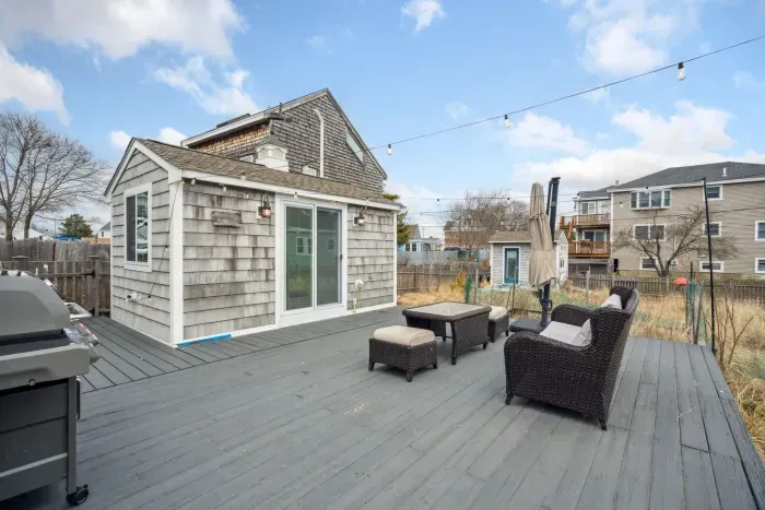 The back deck with string lights and the bunk house!