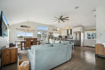 The upstairs living area with a comfy couch and large smart TV. Fully equipped and renovated kitchen along with a full bath are on this floor as well