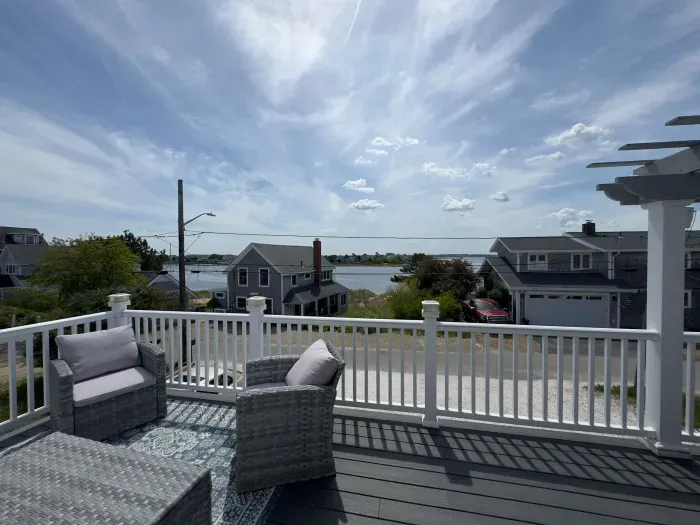 The balcony with outdoor seating, dining, and views of the Plum Island Basin!