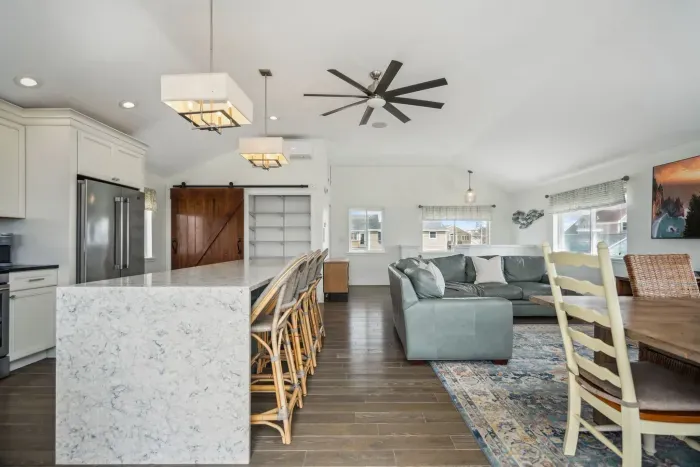 The upstairs living area with a comfy couch and large smart TV. Fully equipped and renovated kitchen along with a full bath are on this floor as well. Seating for 4 at the island