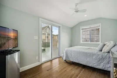 The DETACHED queen bunk house!! With a Roku smart tv and queen bed. This room is intended for SUMMER USE ONLY. It is lockable from the inside. It is ideal for adults, not children as it is not attached to the house. Clean linens provided