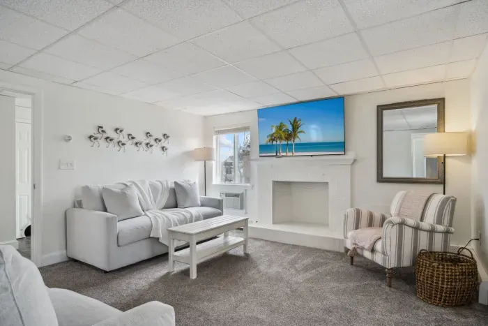 The downstairs living room! With 2 comfy couch and a large smart TV. Please note the fireplace is inoperable