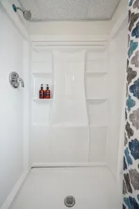 The downstairs shower! This is a standing shower, the laundry is also located in this bathroom. Clean towels provided for all guests
