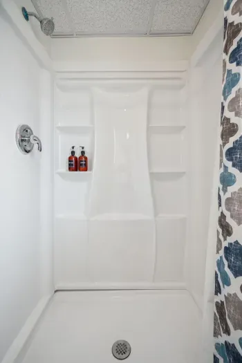 The downstairs shower! This is a standing shower, the laundry is also located in this bathroom. Clean towels provided for all guests