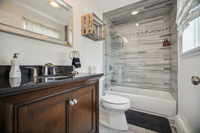 The full bathroom located on the upper level. This bathroom is recently renovated with a shower and tub combo. Clean towels provided for all guests