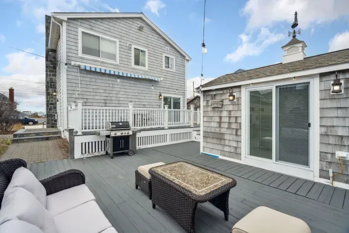The back deck with string lights and the bunk house!
