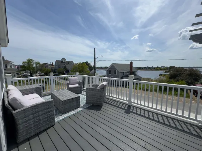 The balcony with outdoor seating, dining, and views of the Plum Island Basin!