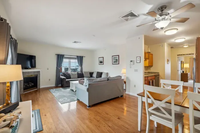 View of the dining area featuring a 4-seater dining table and the living room with ocean views