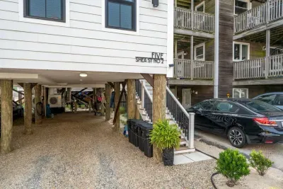 Parking area below the building. The stairway leads to the main entrance. 

PLEASE NOTE - This set of stairs is the only access to the townhome. There is no ground living level.