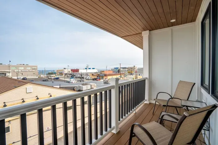 Balcony with outdoor seating right off of the second floor living area and ocean views.
