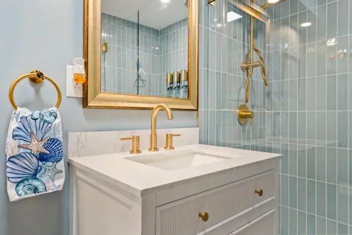 Bathroom #1 features a large standing tile shower, shampoo, body wash, conditioner, and clean towels.
