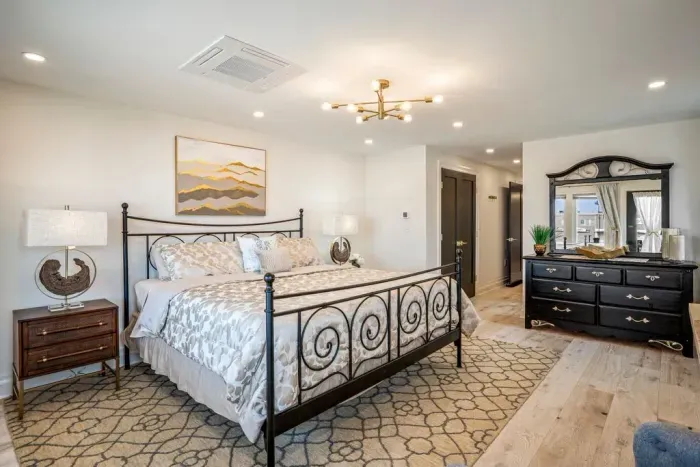 Master bedroom with king size bed and private deck featuring ocean views. Large closet and dresser available for storage.