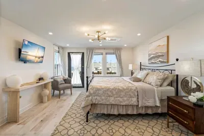 Master bedroom with king size bed and private deck featuring ocean views. Large closet and dresser available for storage.